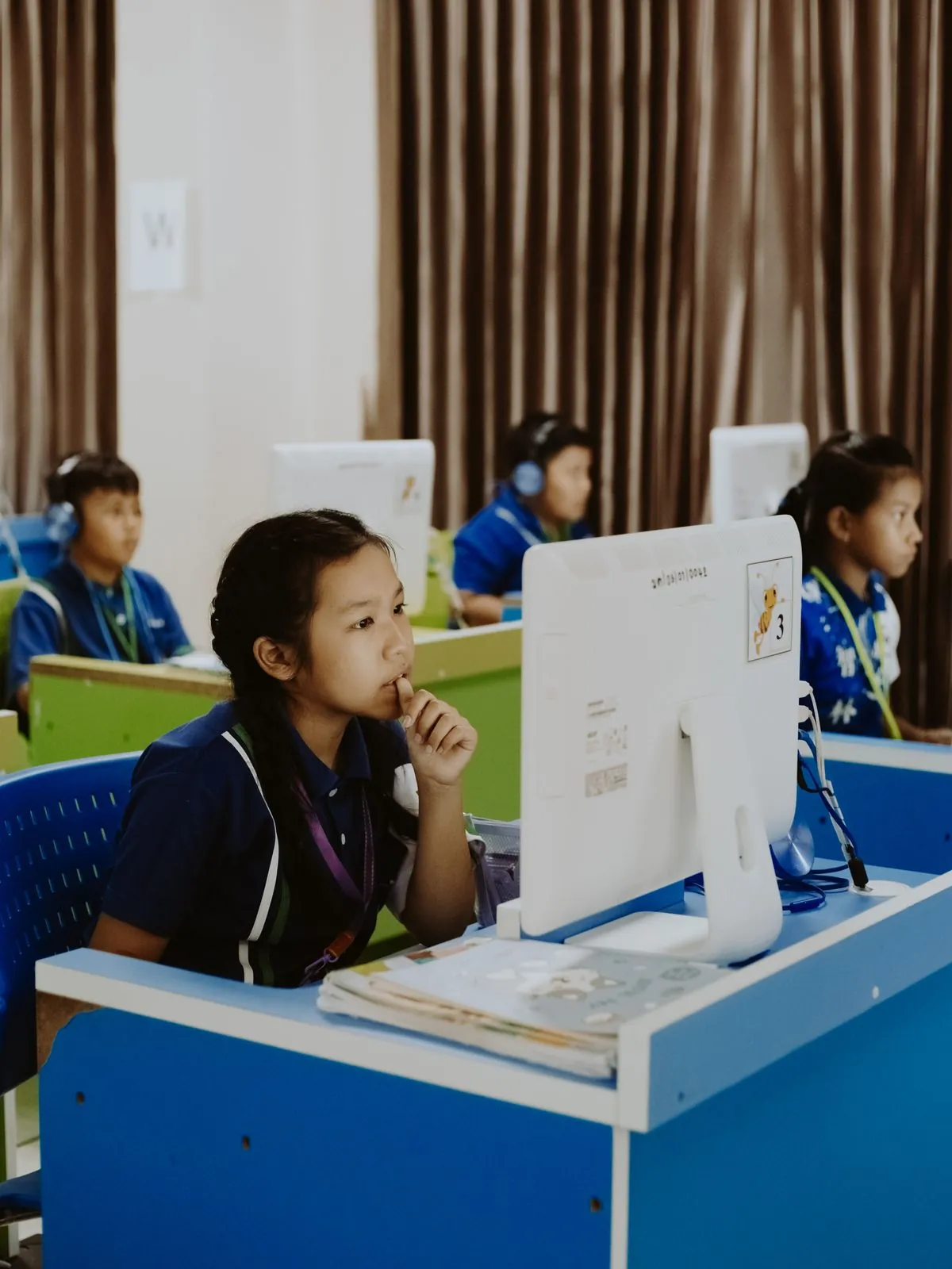 Pupils working at computers in a school classroom